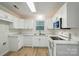 Bright kitchen with white cabinets, marble countertops, and stainless steel appliances at 519 Jacobs Rdg, Fort Mill, SC 29715
