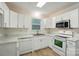Bright kitchen with white cabinets, marble countertops, and stainless steel appliances at 519 Jacobs Rdg, Fort Mill, SC 29715