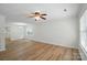 Bright living room with neutral paint, wood-look flooring and ceiling fan at 519 Jacobs Rdg, Fort Mill, SC 29715