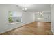 Spacious living room with wood-look floors, two windows, and a ceiling fan at 519 Jacobs Rdg, Fort Mill, SC 29715