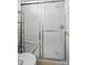 Close up view of sliding shower door with comfort-height toilet and storage shelving at 519 Jacobs Rdg, Fort Mill, SC 29715
