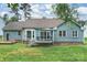 Rear exterior of home with a deck, bay window, and well-maintained lawn at 616 Trailing Rock Dr, Charlotte, NC 28214