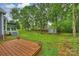 Expansive backyard with a wooden deck, shed, lush lawn, and mature trees, offering privacy at 616 Trailing Rock Dr, Charlotte, NC 28214