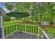 A backyard view from the home's deck, showcasing a large tree and a shed at 616 Trailing Rock Dr, Charlotte, NC 28214