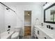 This bathroom features white tile, modern fixtures, and a shower/tub combination at 616 Trailing Rock Dr, Charlotte, NC 28214