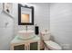 Chic bathroom features a modern sink, white shiplap walls, and a toilet at 616 Trailing Rock Dr, Charlotte, NC 28214