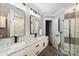 This bathroom features a double sink vanity with marble countertops, modern fixtures, and a glass shower at 616 Trailing Rock Dr, Charlotte, NC 28214