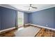 This bedroom features a ceiling fan, hardwood floors, and a window for plenty of natural light at 616 Trailing Rock Dr, Charlotte, NC 28214
