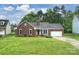 Charming brick home with a lush green lawn and an attached two car garage at 616 Trailing Rock Dr, Charlotte, NC 28214