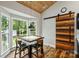 A dining area with large windows and a custom wood barn door adjacent to the kitchen at 616 Trailing Rock Dr, Charlotte, NC 28214