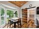 Bright breakfast nook near kitchen features large windows and unique wood barn door to pantry at 616 Trailing Rock Dr, Charlotte, NC 28214