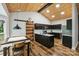 Modern kitchen features dark cabinets, granite countertops, and hardwood floors at 616 Trailing Rock Dr, Charlotte, NC 28214