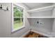 This laundry room features a window, floating shelves, and hook at 616 Trailing Rock Dr, Charlotte, NC 28214