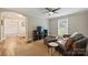 Living room has an arched doorway, a large tv, ceiling fan, and outside view at 616 Trailing Rock Dr, Charlotte, NC 28214