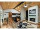 Spacious living area with hardwood floors, wood ceilings, and a fireplace at 616 Trailing Rock Dr, Charlotte, NC 28214
