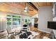 Bright living room with hardwood floors, vaulted wood ceiling, and patio access at 616 Trailing Rock Dr, Charlotte, NC 28214