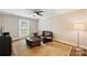 Cozy living room offers a ceiling fan, large window, and comfortable furniture at 616 Trailing Rock Dr, Charlotte, NC 28214