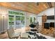 Bright living room features hardwood floors, vaulted wood ceiling, and patio access at 616 Trailing Rock Dr, Charlotte, NC 28214