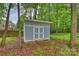 Backyard shed with double doors and ramp, offering extra storage or workspace at 616 Trailing Rock Dr, Charlotte, NC 28214