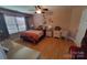 Charming bedroom featuring light wood floors, neutral walls, a ceiling fan, and a comfortable, serene ambiance at 6454 Sain Milling Rd, Vale, NC 28168