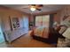 Comfortable bedroom showcasing natural light, light wood floors, and a cozy, inviting atmosphere at 6454 Sain Milling Rd, Vale, NC 28168