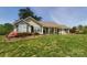 Inviting single-story home with green shutters and lush landscaping in the front yard at 6454 Sain Milling Rd, Vale, NC 28168