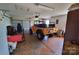 Garage with a yellow vintage vehicle, roll-up door, and ample storage at 6454 Sain Milling Rd, Vale, NC 28168