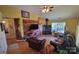 Cozy living room with a stone fireplace, vaulted ceilings, and lots of natural light at 6454 Sain Milling Rd, Vale, NC 28168