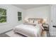 Bedroom featuring large window, queen-sized bed, and lamps at 7212 Canyon Dr, Charlotte, NC 28262