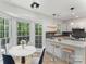 Cozy breakfast nook featuring a bay window, a dining table, and a breakfast bar with modern pendant lighting at 7212 Canyon Dr, Charlotte, NC 28262