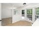 Sunlit breakfast nook with bay windows, tile flooring, and views to the porch offers charm at 7212 Canyon Dr, Charlotte, NC 28262