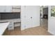Inviting entryway featuring a built-in desk, tile flooring, and an open view to the living area with a fireplace at 7212 Canyon Dr, Charlotte, NC 28262