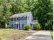 Charming blue two-story home with white trim, black shutters, and lush landscaping, surrounded by mature trees at 7212 Canyon Dr, Charlotte, NC 28262