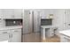 Charming kitchen boasts stainless steel refrigerator, custom cabinetry, and a built-in desk area at 7212 Canyon Dr, Charlotte, NC 28262