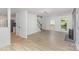 Open-concept living area with wood floors, a fireplace, and ample natural light, offering easy access to other spaces at 7212 Canyon Dr, Charlotte, NC 28262