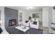 Bright living room featuring a gray fireplace, comfortable seating, and a dining area with access to the outdoors at 7212 Canyon Dr, Charlotte, NC 28262