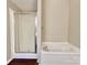 Bathroom featuring a shower with glass door and a white bathtub at 7401 Kinsmore Ln, Charlotte, NC 28269