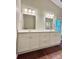 Bright bathroom featuring a double vanity with two mirrors and modern light fixtures at 7401 Kinsmore Ln, Charlotte, NC 28269