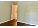 Bedroom with wood look flooring and doorway to upper level at 7401 Kinsmore Ln, Charlotte, NC 28269