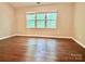 Bright bedroom featuring hardwood floors and natural light at 7401 Kinsmore Ln, Charlotte, NC 28269