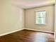 Well lit bedroom with hardwood floors and a view of nature at 7401 Kinsmore Ln, Charlotte, NC 28269