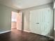 Bright bedroom with ample closet space and wood-look flooring at 7401 Kinsmore Ln, Charlotte, NC 28269