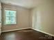 Clean bedroom offers a serene view through its window and features modern flooring and neutral walls at 7401 Kinsmore Ln, Charlotte, NC 28269