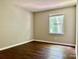 Bright, empty bedroom with wood floors, neutral paint, and a large window at 7401 Kinsmore Ln, Charlotte, NC 28269