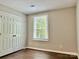 Cozy bedroom featuring a double door closet and bright window at 7401 Kinsmore Ln, Charlotte, NC 28269