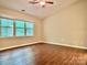 Sunlit bedroom featuring a large window with a green view at 7401 Kinsmore Ln, Charlotte, NC 28269