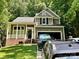 Charming two-story home with a covered front porch, attached garage and well-maintained lawn at 7401 Kinsmore Ln, Charlotte, NC 28269