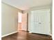 Hallway with wood floors, neutral paint, closet, and access to other rooms at 7401 Kinsmore Ln, Charlotte, NC 28269