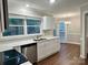 Modern kitchen featuring white cabinets, stainless steel appliances, and a sleek countertop at 7401 Kinsmore Ln, Charlotte, NC 28269