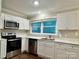Bright kitchen featuring white cabinets, stainless steel appliances, and natural light at 7401 Kinsmore Ln, Charlotte, NC 28269